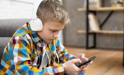 Boy with headphones using a smartphone