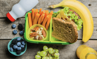 lunchbox with bread, veggies, fruits, and milk