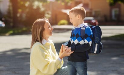mother kid first school day side view